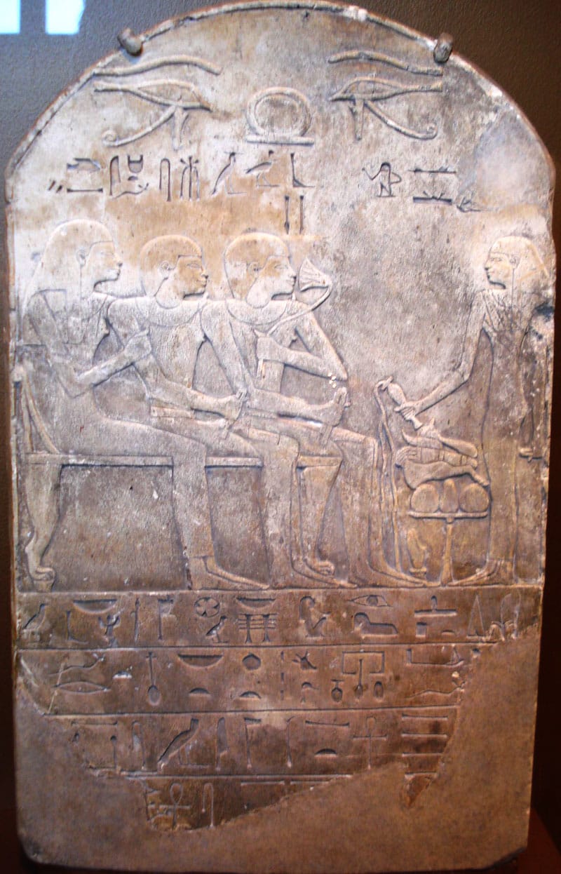 Ancient Egyptian funerary stele of a man named Ba (seated, sniffing a sacred lotus while receiving libations)