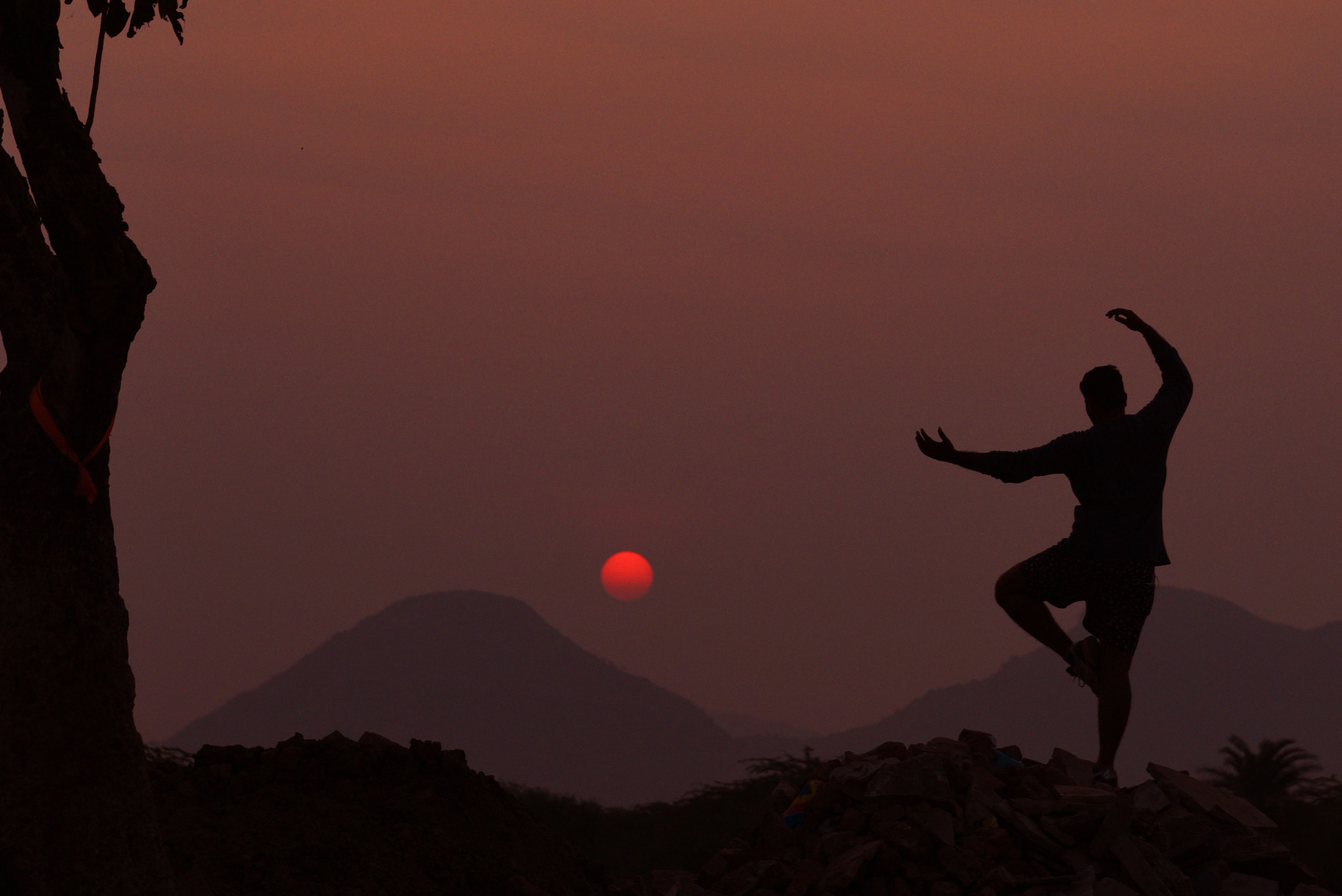a man performing tai chi on a mountain